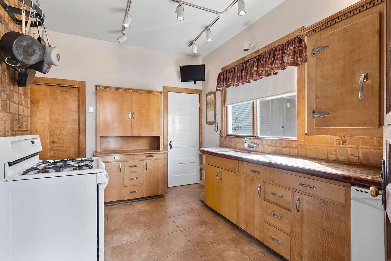 Kitchen with Batchelder tile counter tops and backsplash