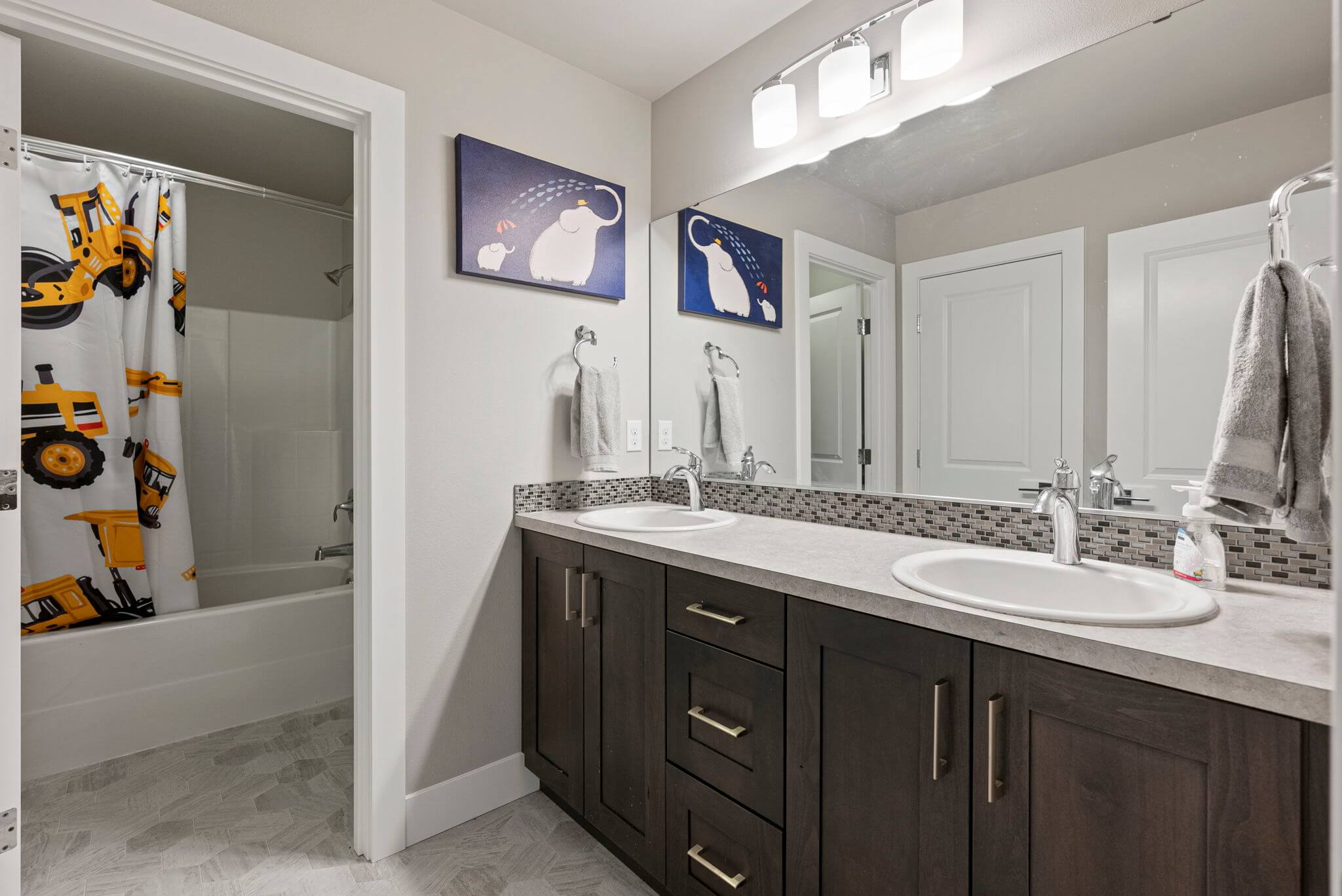 Upstairs full bathroom with dual sink vanity