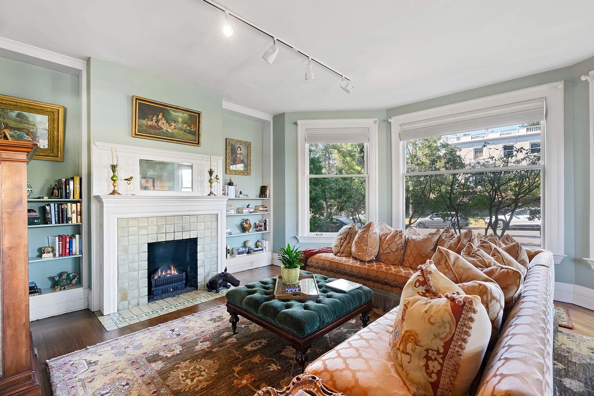 Formal living room with gas fireplace, vintage coal basket and original tile surround