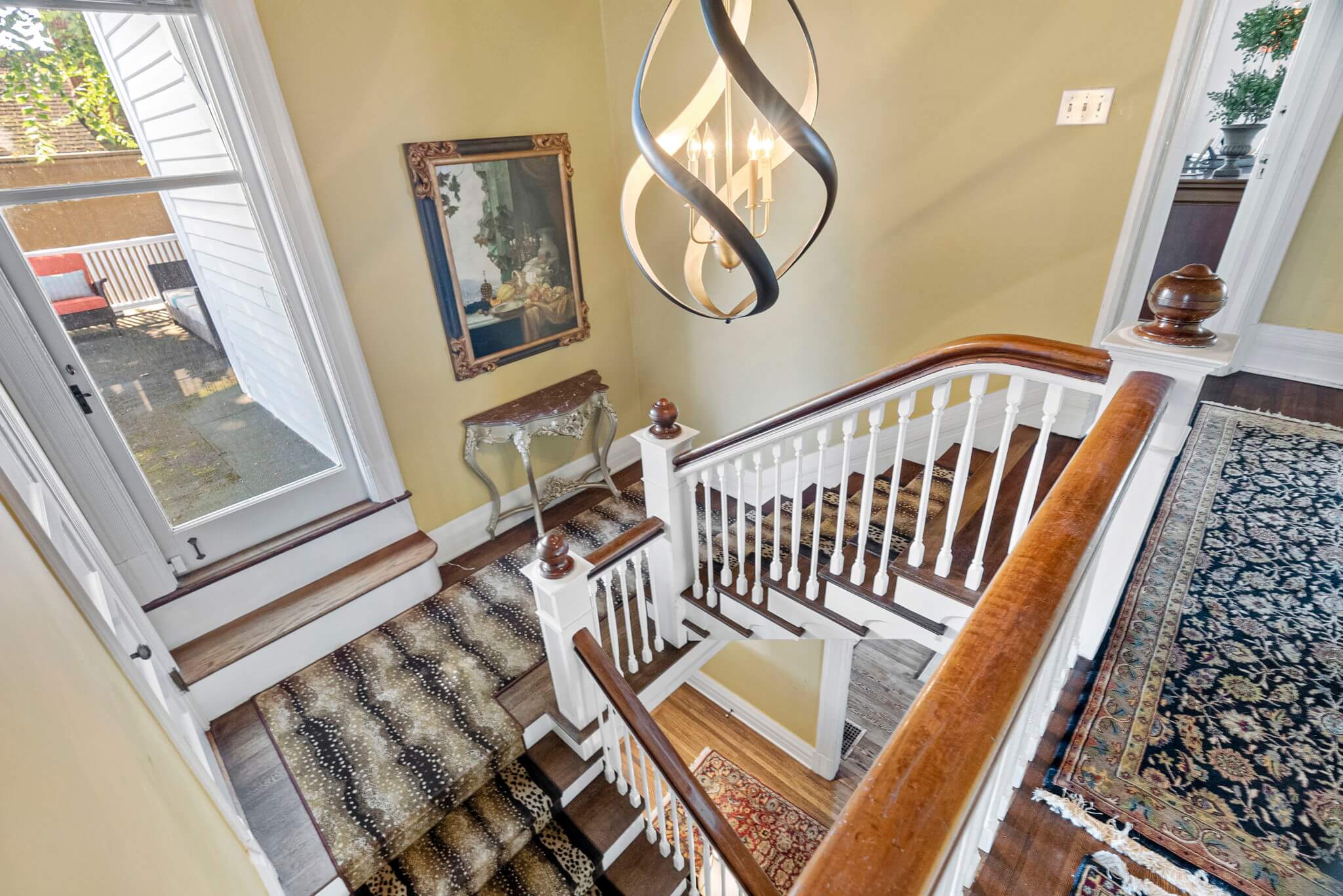 The formal staircase offers access to a roof-top deck over the porte-cochere