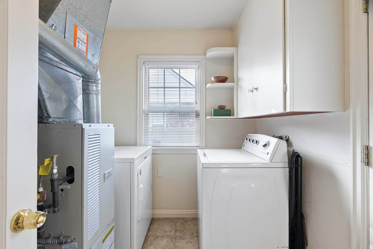 Laundry room off kitchen offers access to back yard
