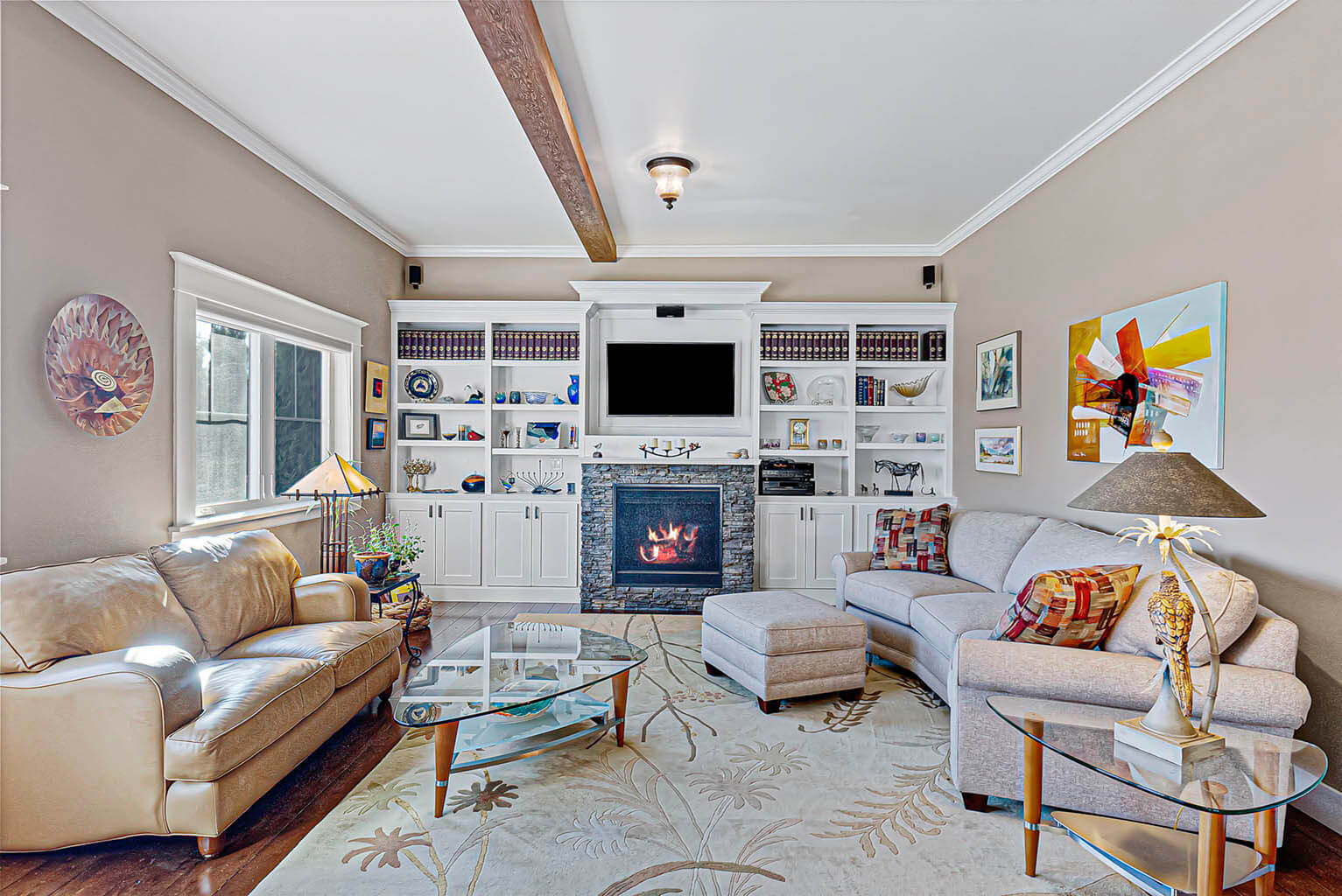 Spacious living room with gas fireplace and custom built-ins