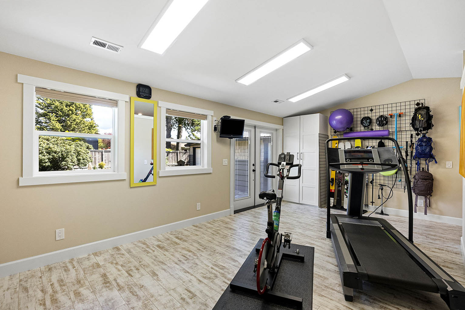 French doors in exercise studio open to back yard