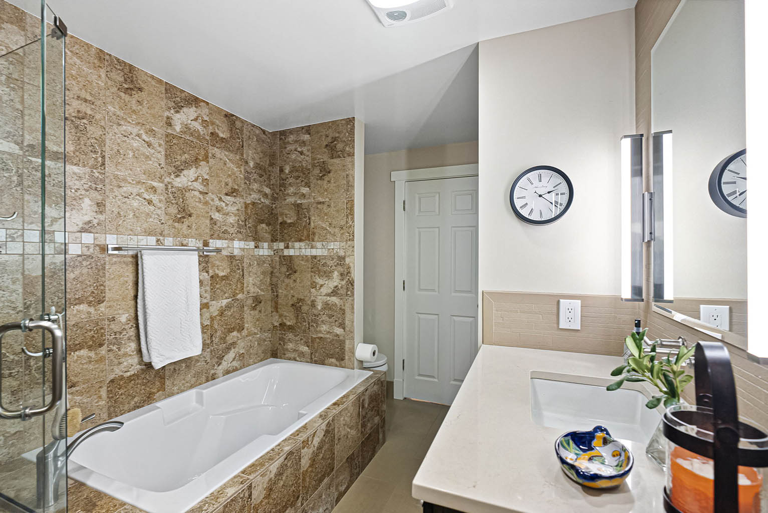 Primary bathroom with soaking tub is accessible from the hall