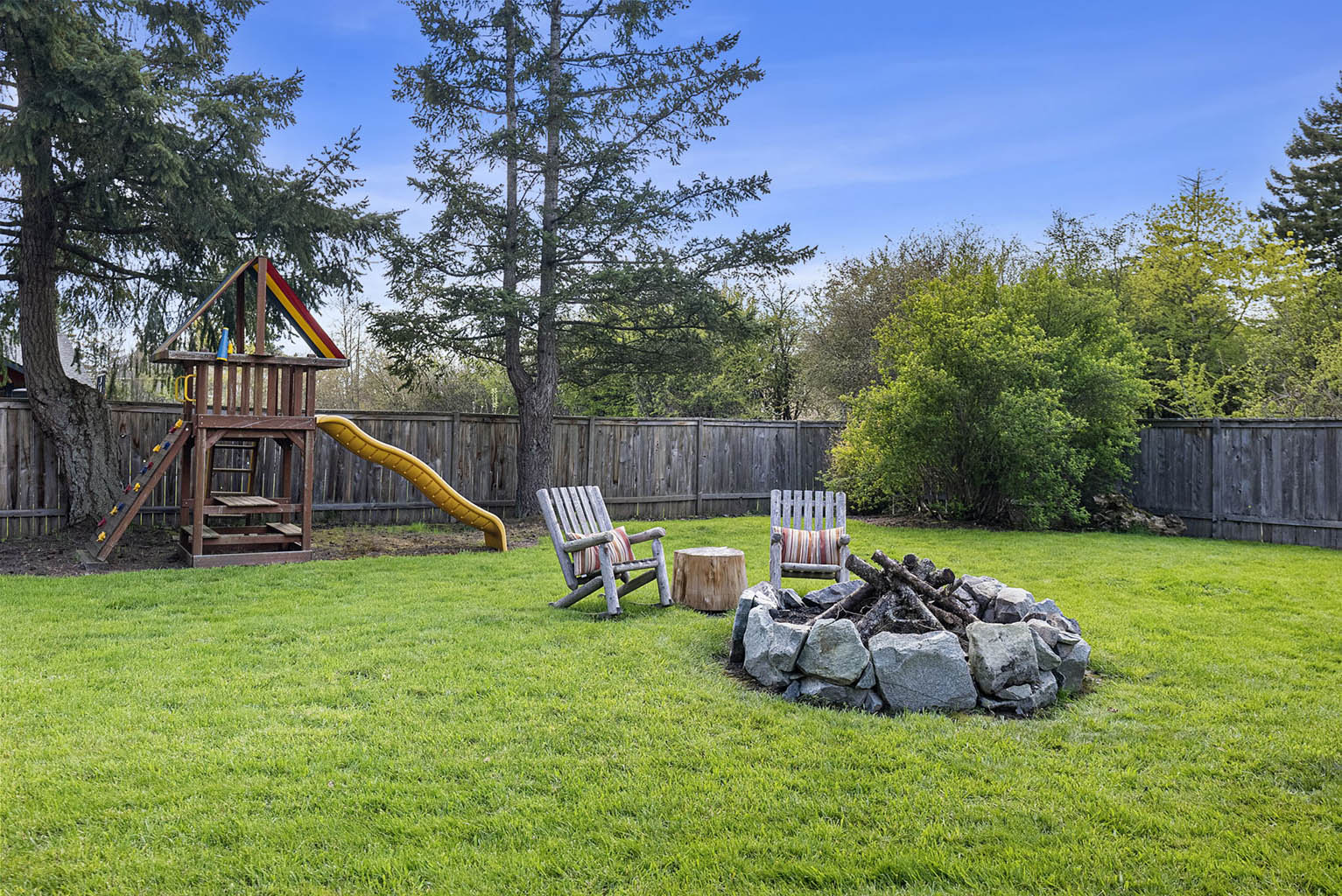 Fully fenced back yard with fire pit