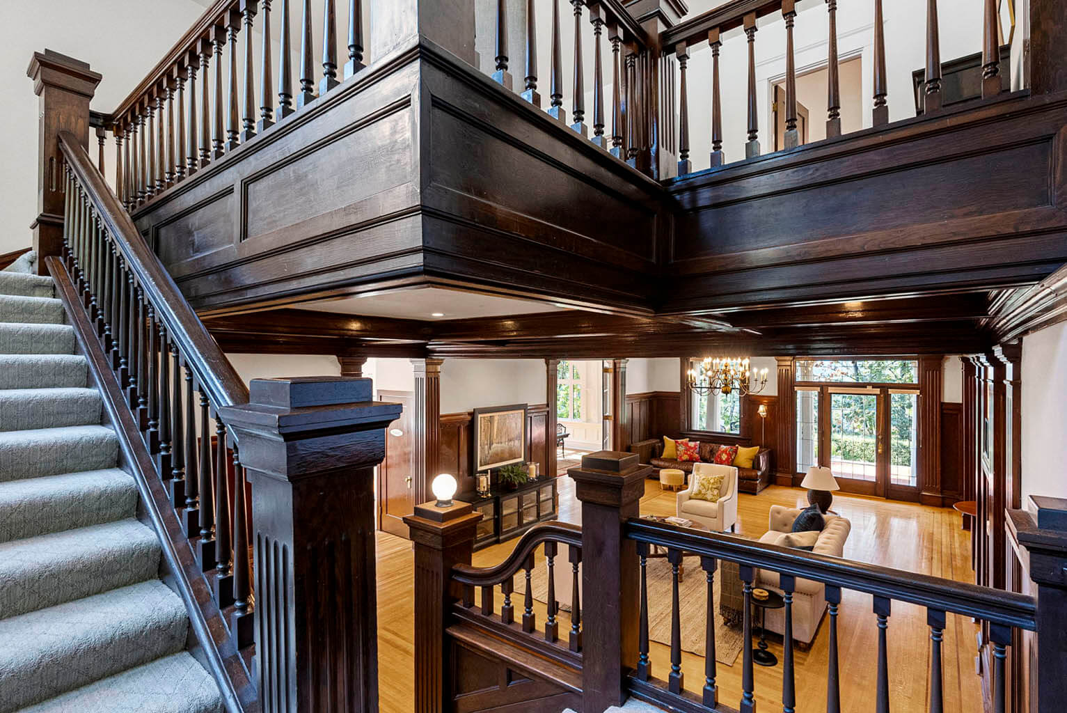 Grand staircase is open to the living room