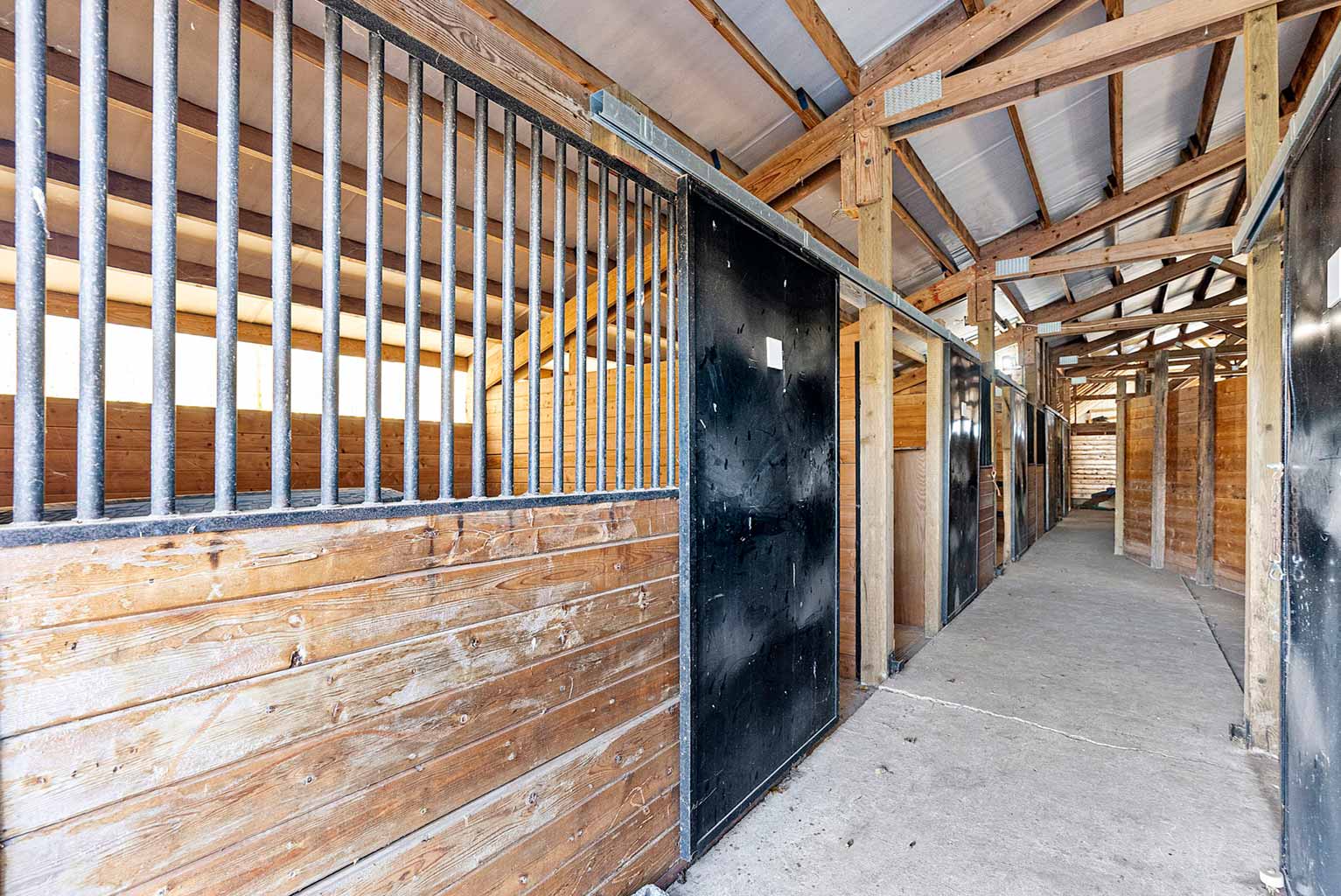 The smaller barn includes eight 12' x 12' rubber matted stalls