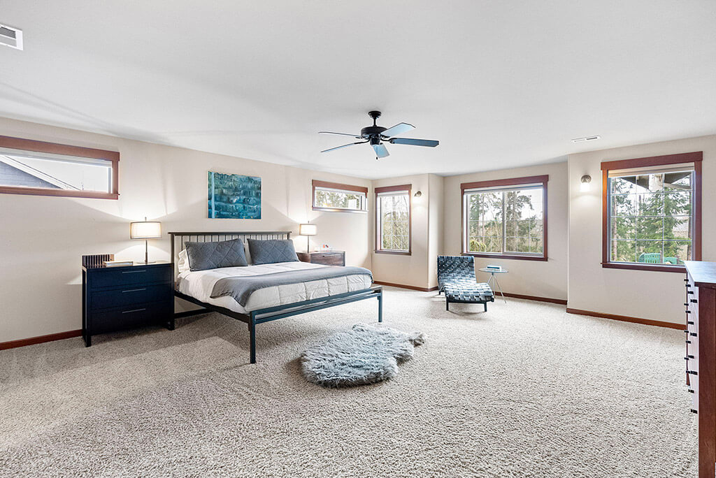 Spacious primary bedroom with ceiling fan