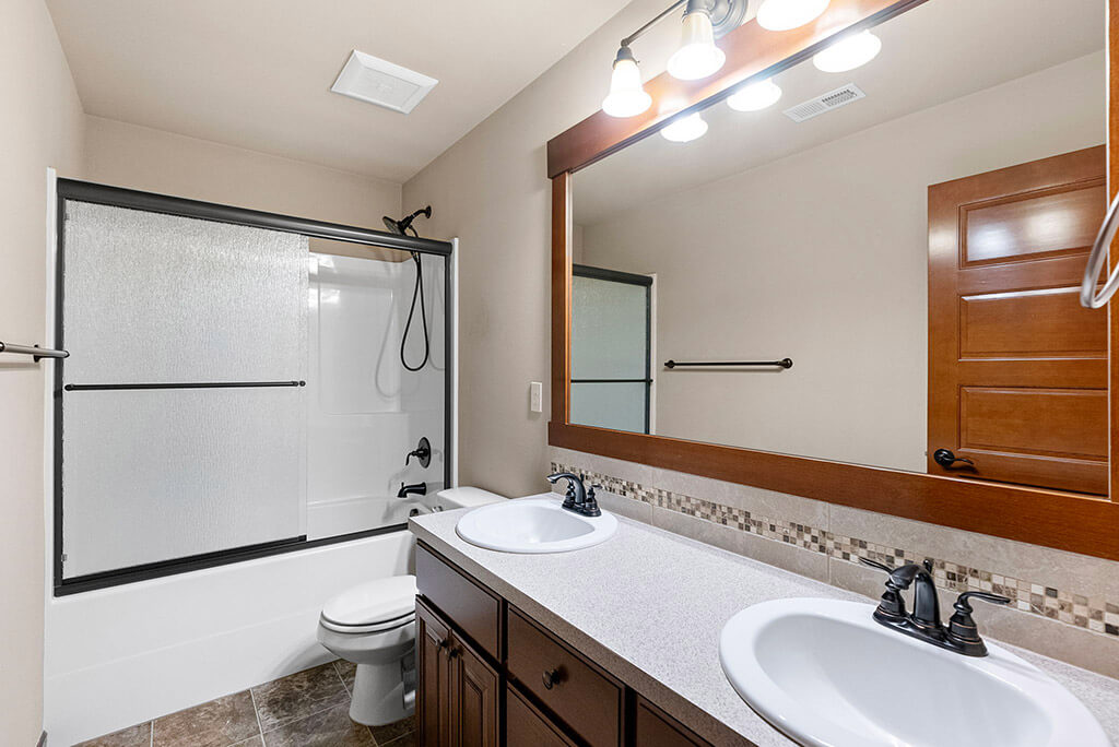 Full hall bathroom with dual sink vanity