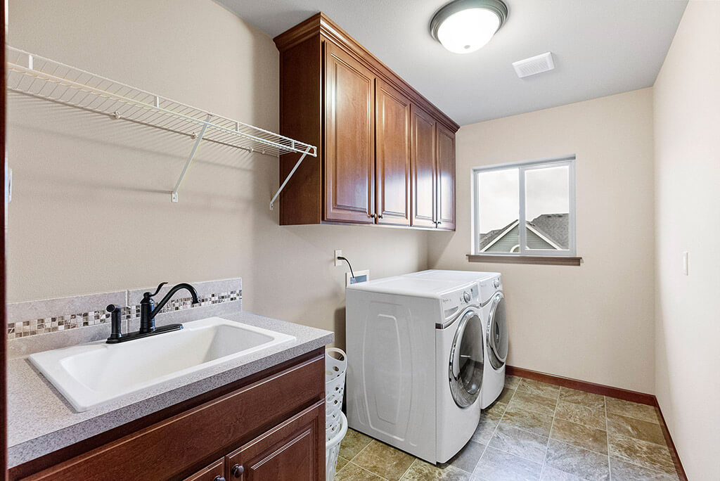 Upstairs laundry room with utility sink