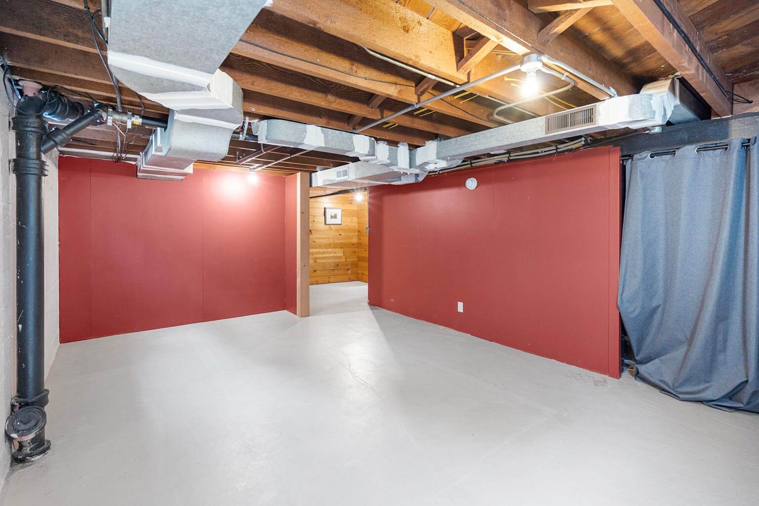 Unfinished basement with ample ceiling height offers opportunity for expanded living space
