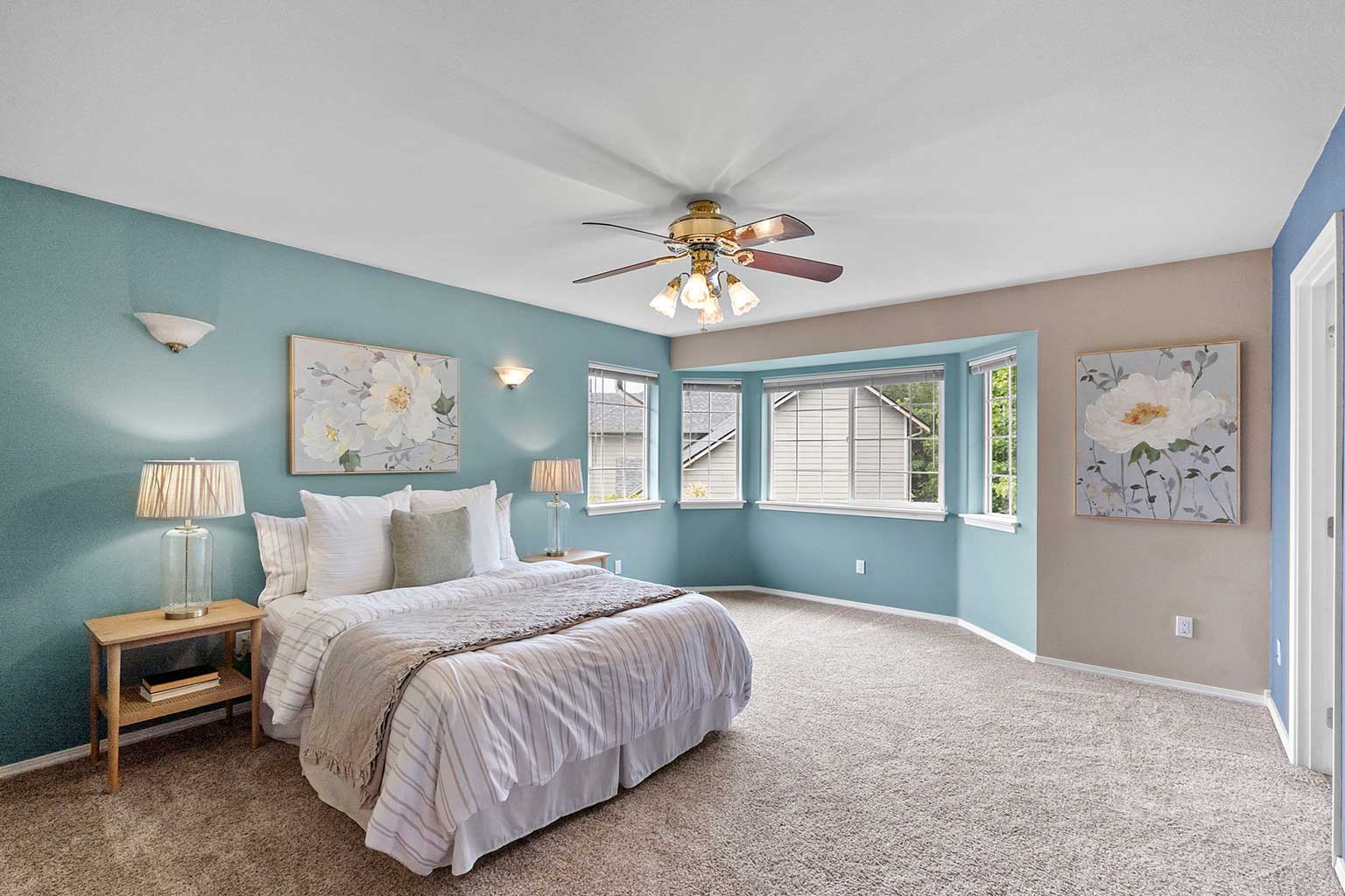 Spacious primary bedroom with bay window