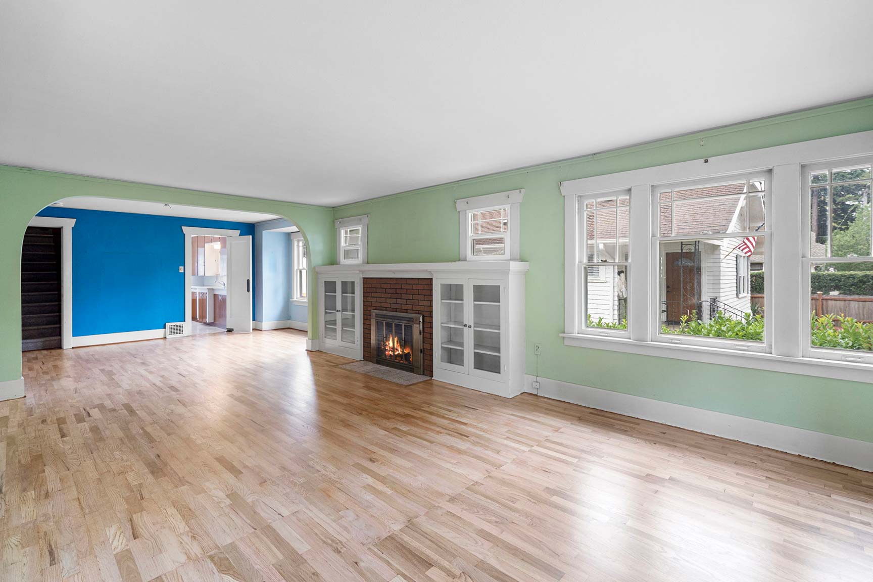 Spacious living room with refinished hardwood floors