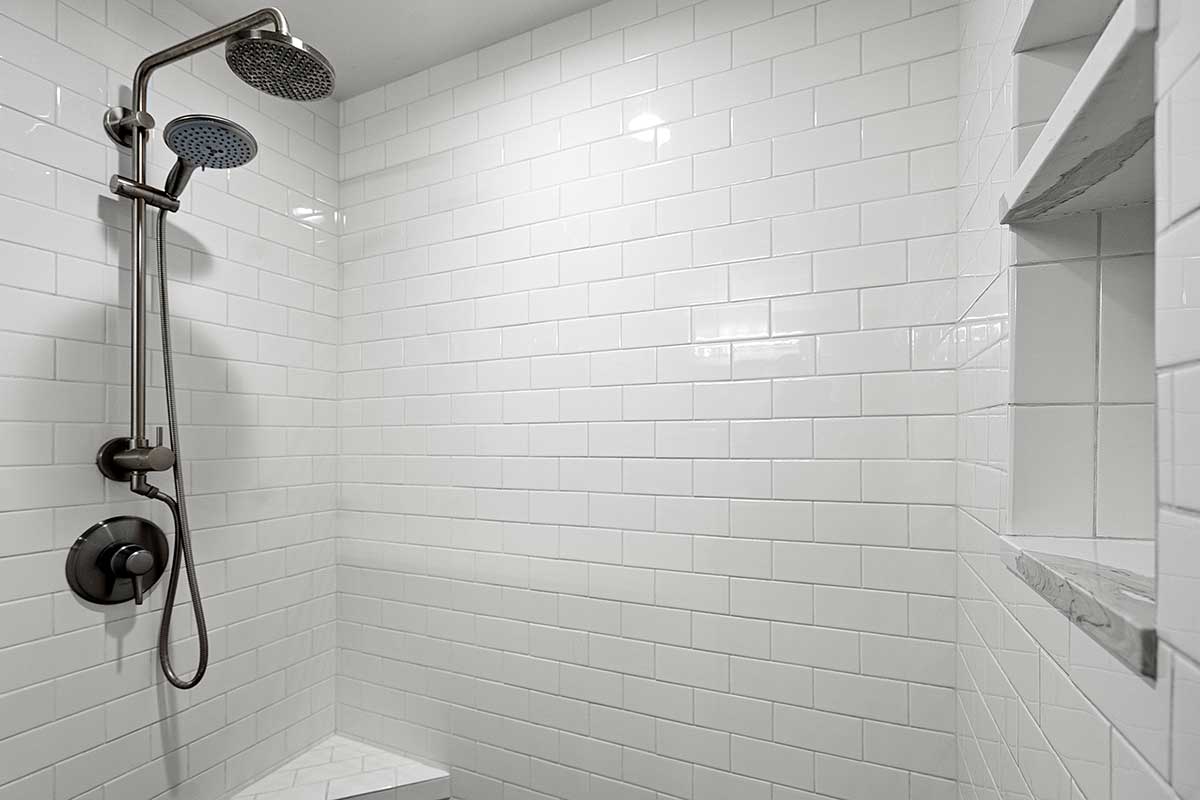 Subway-tiled walk-in shower in the primary bathroom