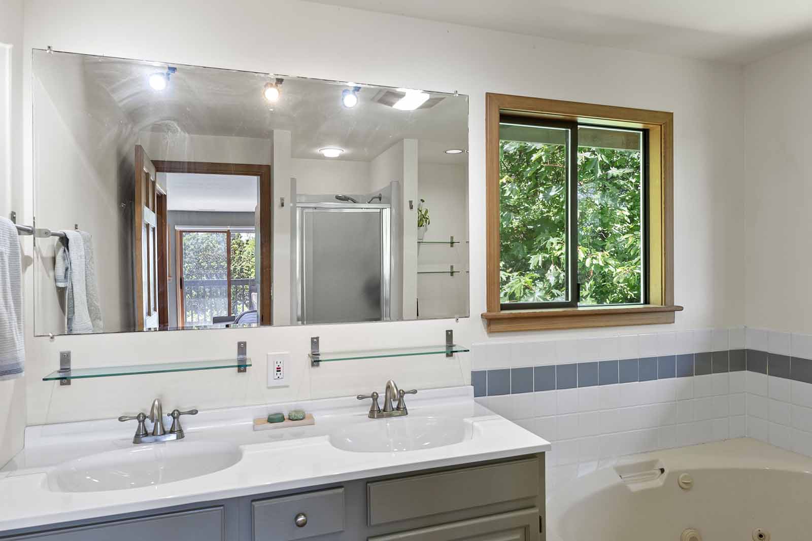 Primary bathroom includes a dual sink vanity, soaking tub and separate shower