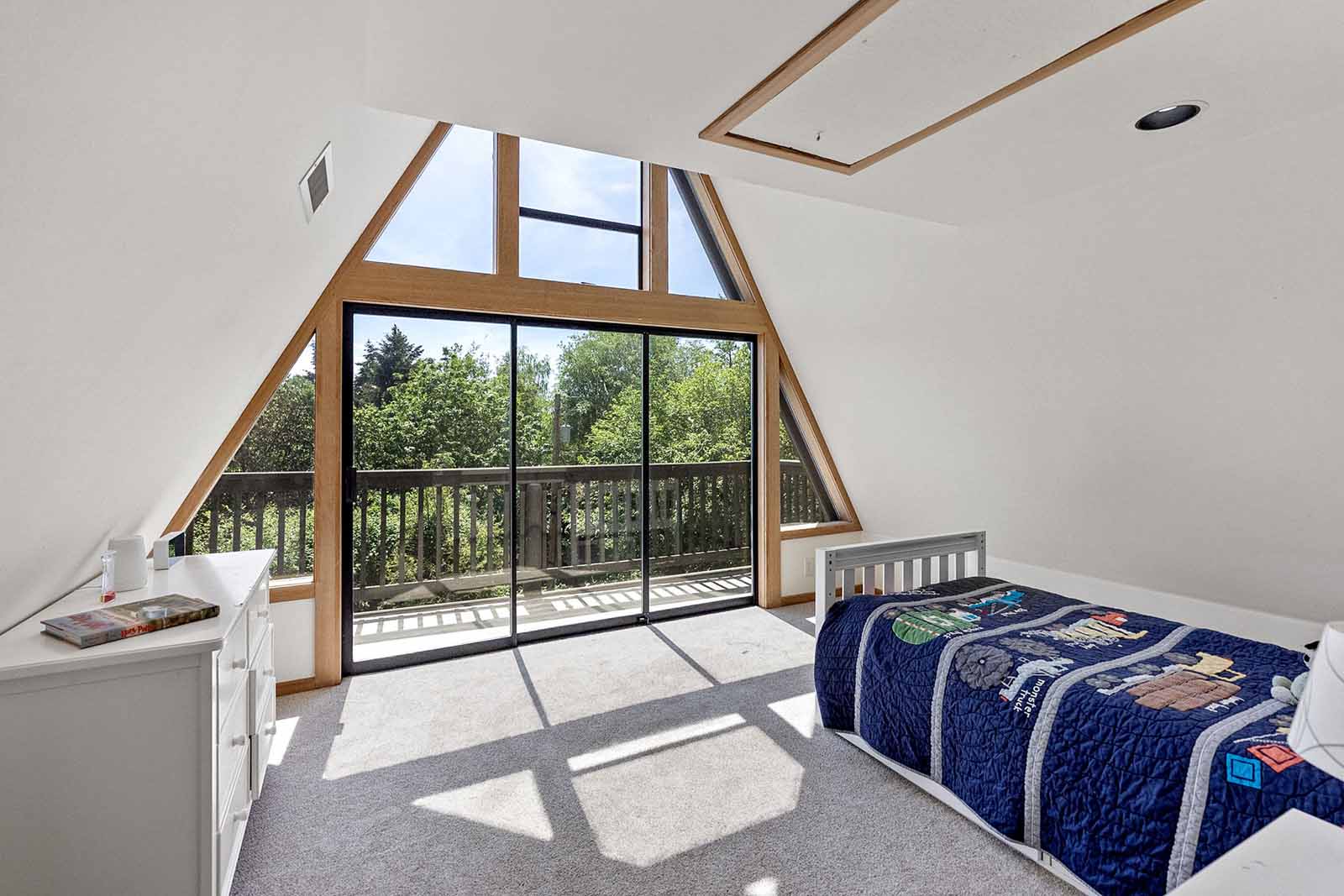 Second bedroom features vaulted ceiling, loft and private balcony