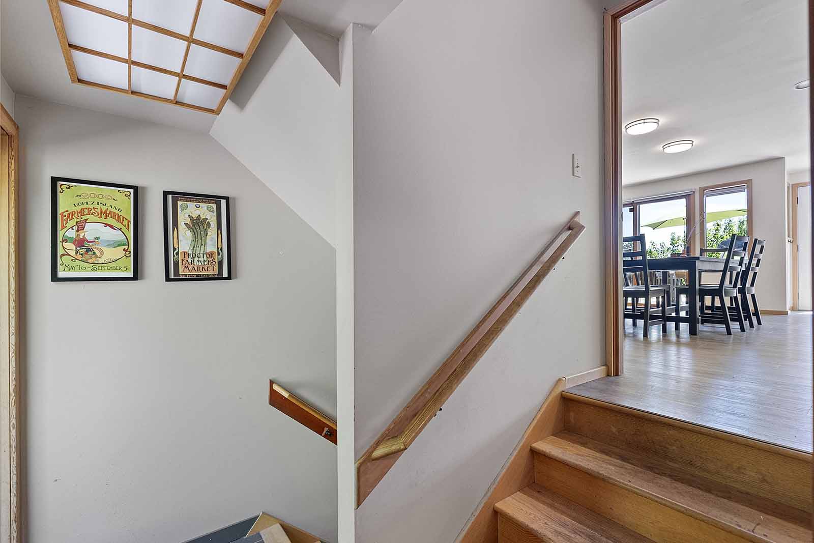 Stairs from main level to laundry, rear patio and lower level