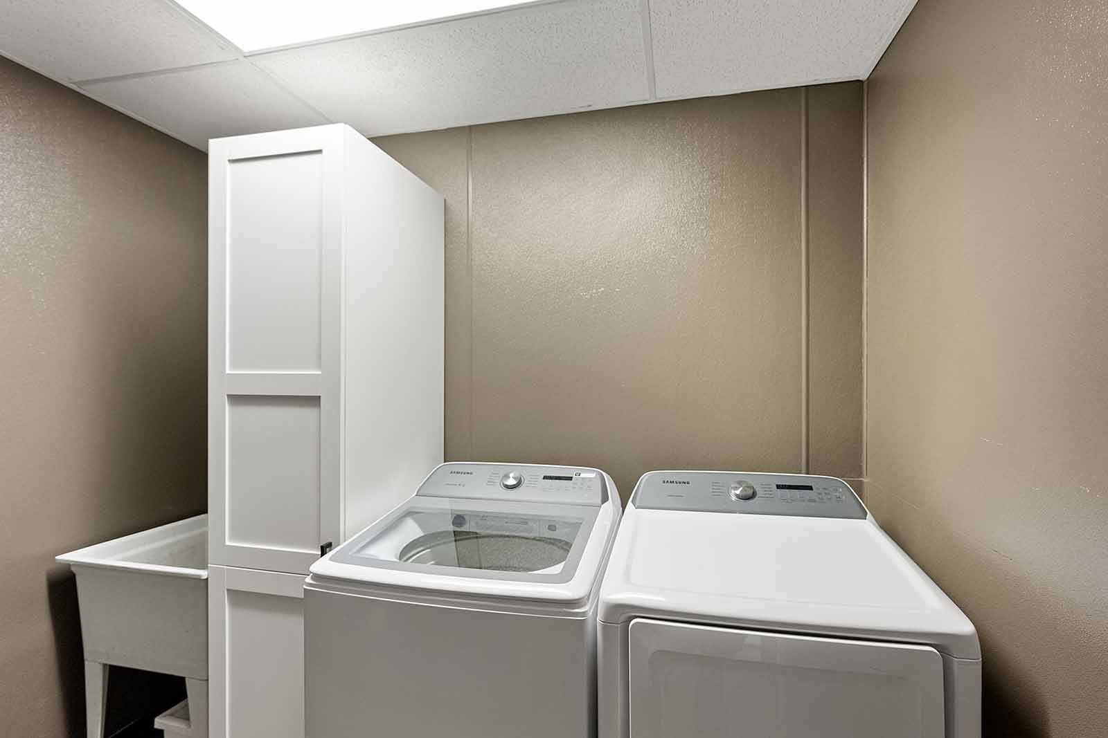 Laundry room with new washer/dryer and utility sink