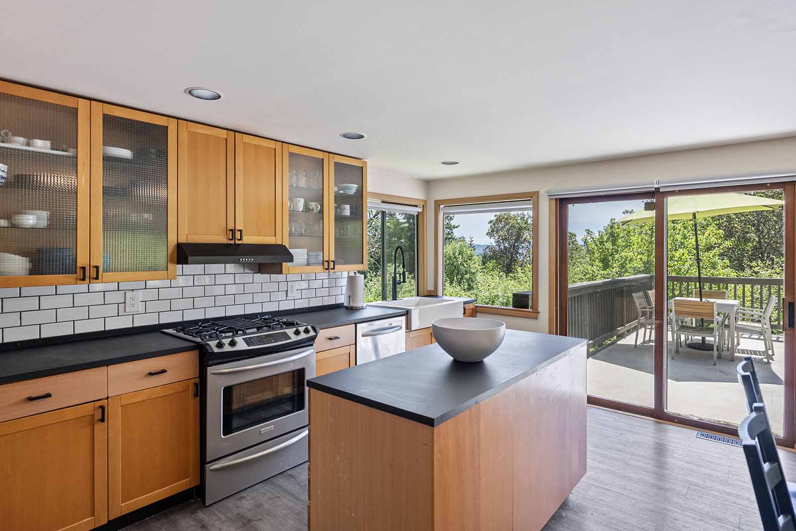 Updated kitchen with central island and stainless appliances