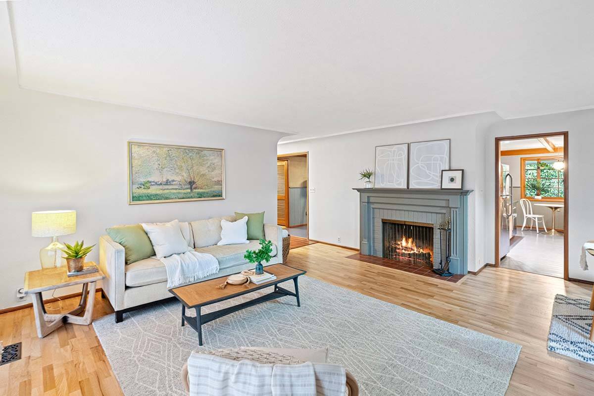 Living room with wood burning fireplace and kitchen access