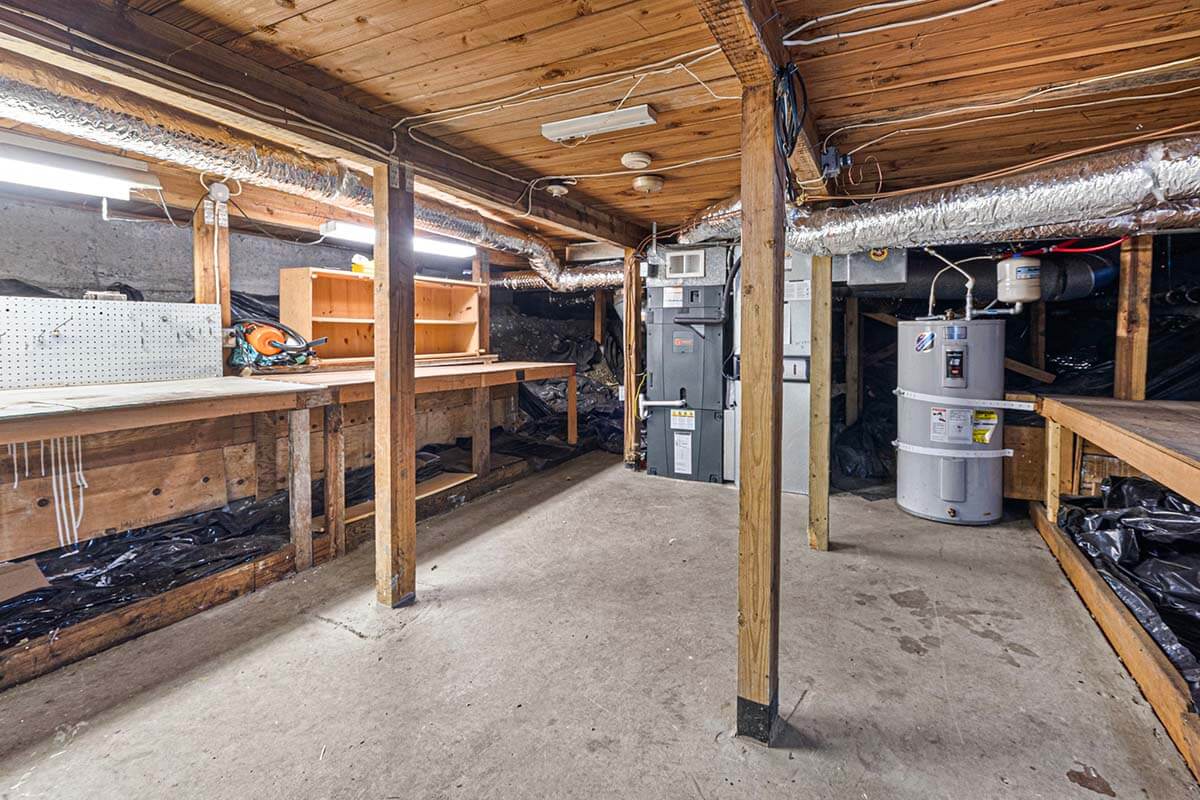 Unfinished cellar with exterior access offers ample room for storage and shop