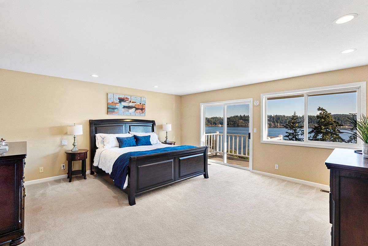 Spacious primary bedroom with private view deck