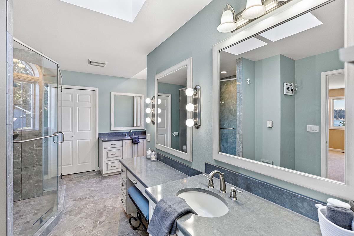 Updated primary bathroom with double vanities and linen storage