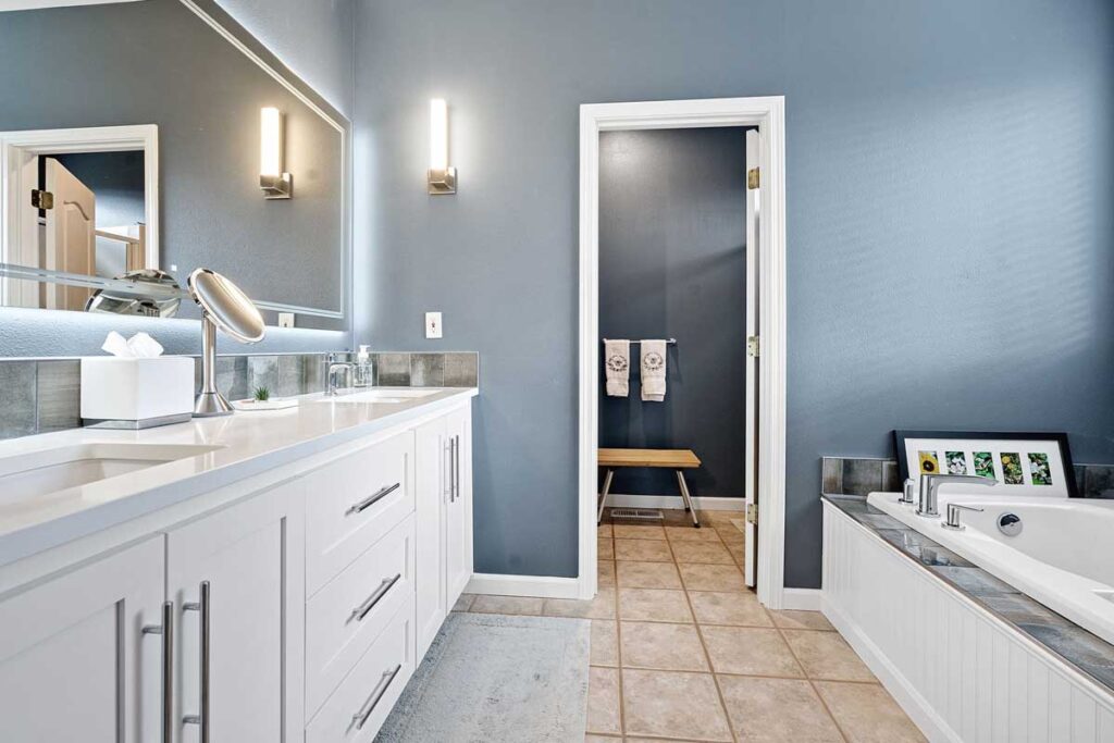 Updated primary bathroom with dual sink vanity and soaking tub