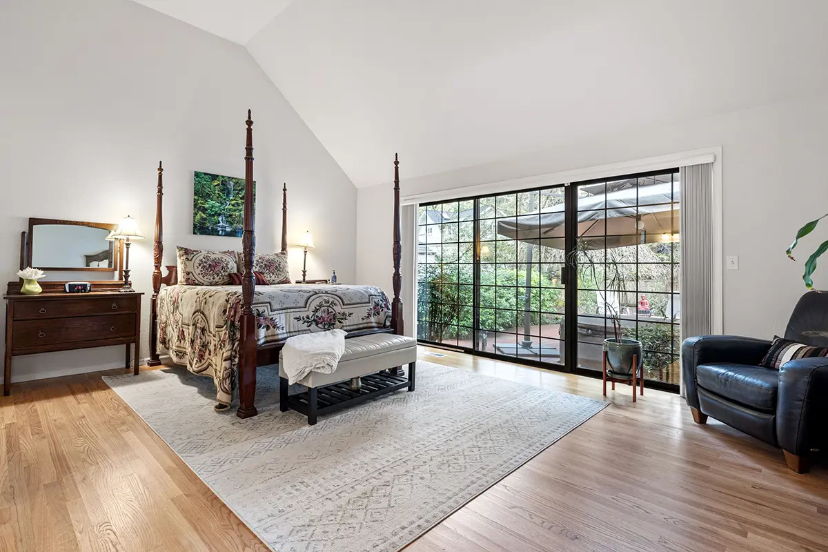 Main floor primary bedroom with patio access and blackout curtains