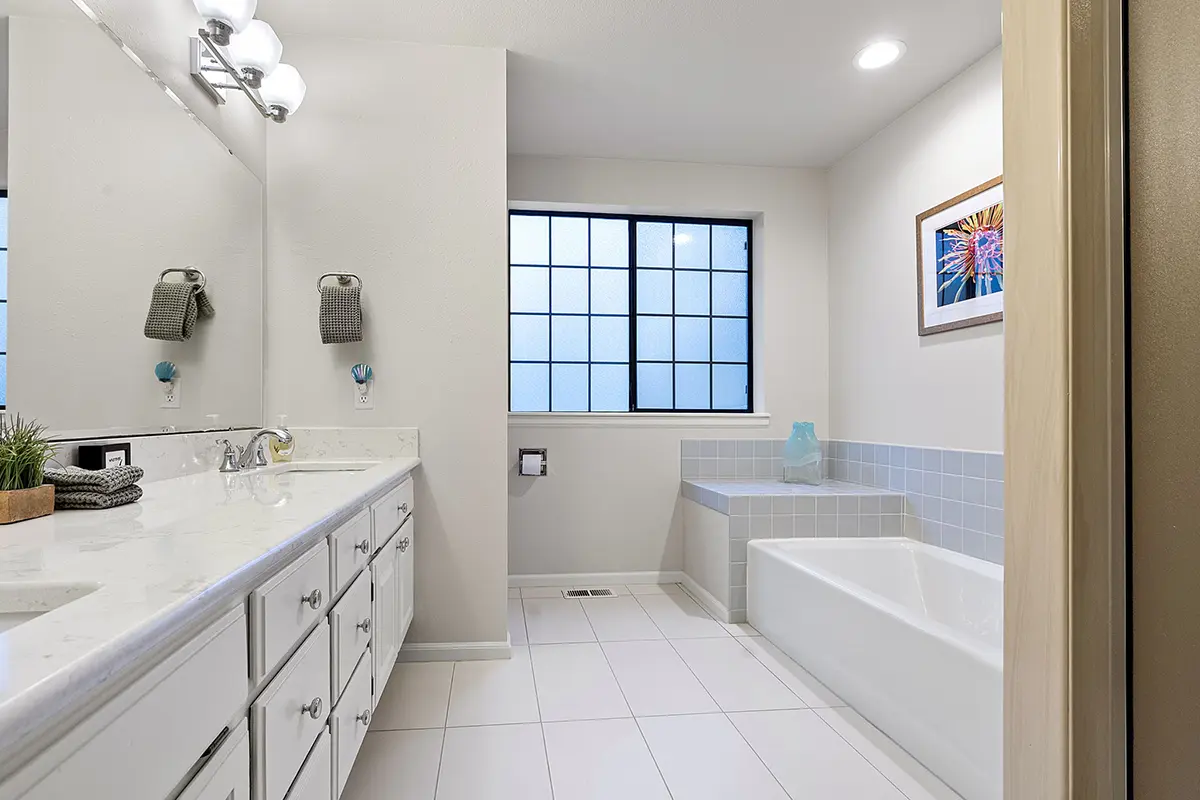 Full bathroom upstairs with separate tub and shower and dual sink vanity